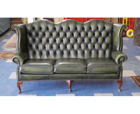 A Green Leather Upholstered Button Back Three Seater Settee on Short Cabriole Legs