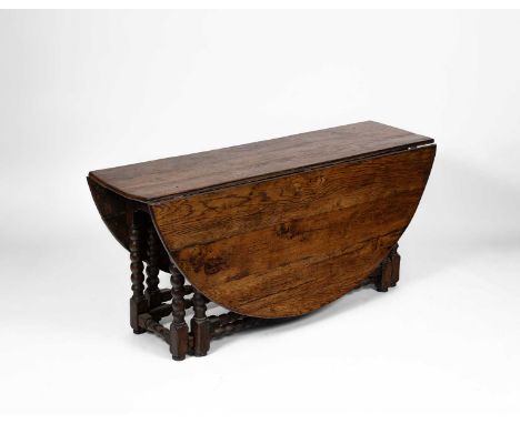 An early 18th Century oak and elm gateleg table, on bobbin supports united by stretchers, 166cm wide, 173cm deep, 75cm highst