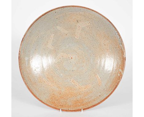 Warren MacKenzie (1924-2018) a stoneware charger, pink shino glaze with masked geometric motifs in the well, 9.2cm high x 41.