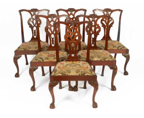 A set of six Chippendale style dining chairs with splat backs, drop-in seats and on carved cabriole front legs with claw and 