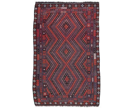 A large Maiman kilim, Afghanistan, the abrashed panel aubergine field with an all over design of open lozenge patterned medal