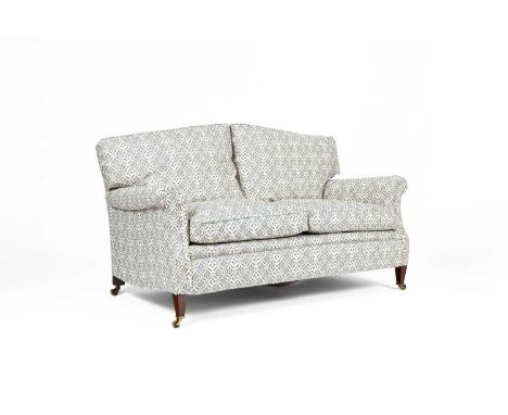 A Howard &amp; Sons sofa, recently reupholstered, the arched loose twin cushion back above a loose twin cushion seat, with sc