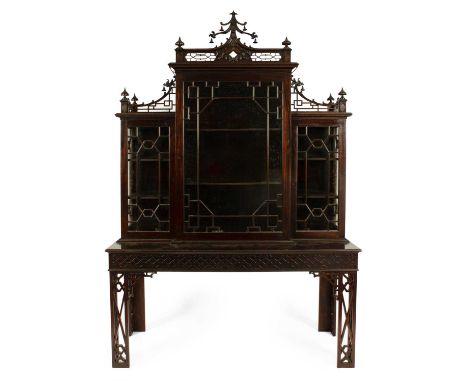 A Chinese Chippendale style display cabinet on stand early 20th Century, the upper cabinet sections with fretwork galleries, 