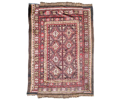 A Julkhyr carpet Uzbekistan, circa 1900, woven in three strips, the deep aubergine field of stellar and hooked guls framed by