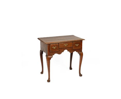 A George III elm lowboy fitted with three drawers above a shaped apron, on cabriole legs with pad feet, 80cm wide, 47.5cm dee