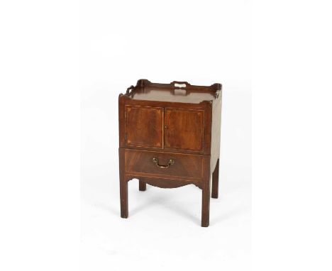 A Georgian mahogany bedside commode, the galleried top with pierced carrying handles, above veneered cabinet doors and an oak