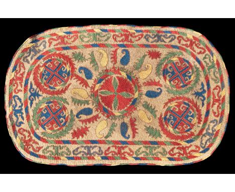A polychrome embroidered felt saddle rug, Uzbekistan, the camel field centred by a circular pinwheel medallion issuing polych