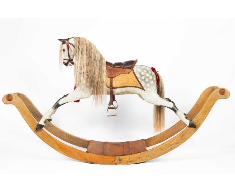 A fine English bow rocking horse by FH Ayres of London, circa 1880, with a chiselled head and carved tongue, glass eyes and e