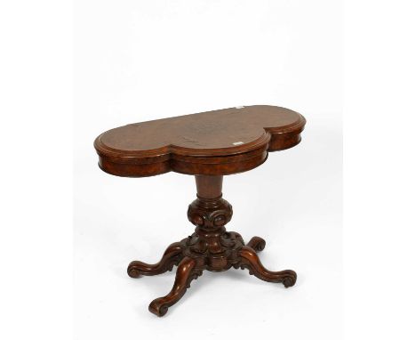 A Victorian burr walnut fold-over tea table, the lobed top with moulded edge on a turned and carved column and four scrolling