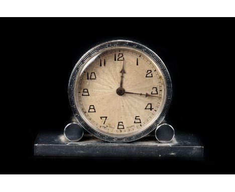 An Art Deco chrome plated table clock,  with Greek key pattern bezel, sunburst dial, and arrow hands, 5.8cm high