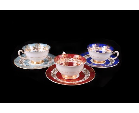 A set of twelve Royal Grafton porcelain cups saucers and side plates, with gilt and floral decoration in pairs of six colours