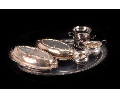 A large silver plated oval twin handled tray, together with a pair of silver plated serving dishes, a silver plated milk jug 