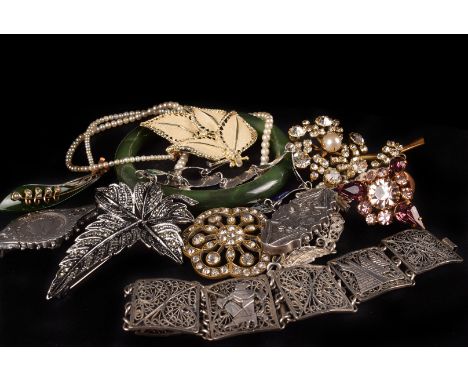 A group of silver and other jewellery, including a spinach jade bangle, pendant and brooch, two filigree bracelets, three chi