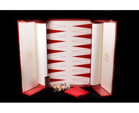 A Cartier Presentation box with Backgammon interior, covered in red with gold coloured block edging and red and white game bo