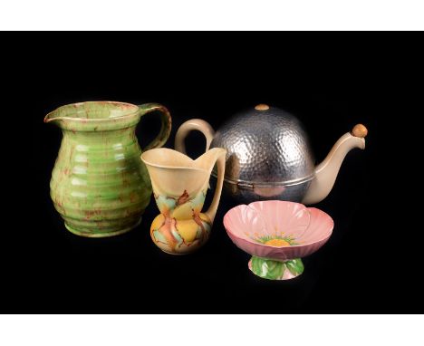 A Torquay ware puzzle jug, together with other examples, Swinnertons Hampton Ivory  green and red lemonade jug and 5 beakers,