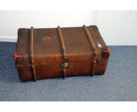 A vintage travel or school trunk, in brown canvas with wooden struts