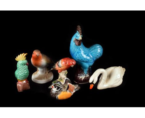 A collection of ceramic birds, including a Meissen style sparrow, a pair of Beswick swans, two Poole sparrows, two Chinese ex