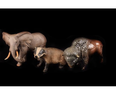 A collection of ceramic animals and other items, including two Lenox elephants, a Beswick style bison, a Wade figure of a boy