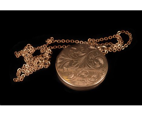 A modern 9ct gold locket, circular with engraved design, supported on a 9ct gold chain, approx 14.5g