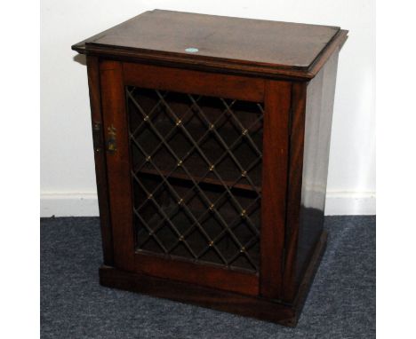 A small 19th century mahogany book cabinet, rectangular form with pierced brass grill to front of door, opening to reveal ope