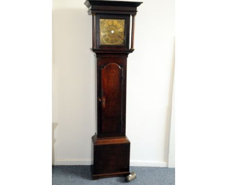 A Georgian oak long case clock, having brass dial with Roman numerals and four classical figures, 30 hour chain movement with