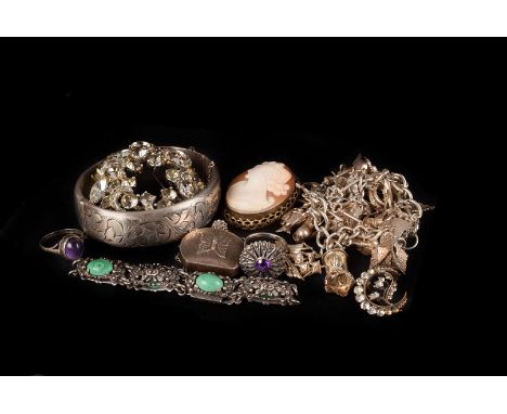 A silver and white metal charm bracelet and other jewellery, the bracelet with many charms such as a skeleton clock, cuckoo c