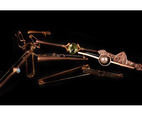 A group of nine gold and other bar brooches, some examples set with gem stones, one in the form of a hunting horn and others,
