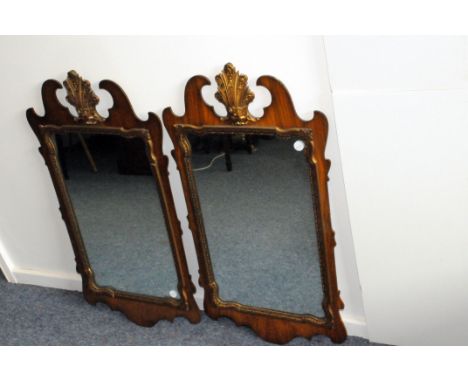 A pair of reproduction Regency Chippendale style mirrors, the fretwork mounts with shell above looking glass (2)