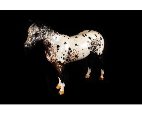 A Beswick pottery horse, with black rocking horse style decoration and beige hooves, 20cm