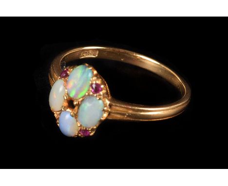 An opal and ruby ring,  the opals set in quatrefoil, with ruby accents, central stone missing, to an 18ct yellow gold shank, 