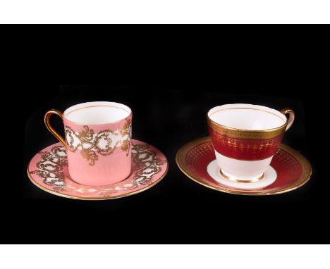 An Aynsley porcelain coffee set, the set of six cups and saucers with red ground and gilt decoration, together with another A