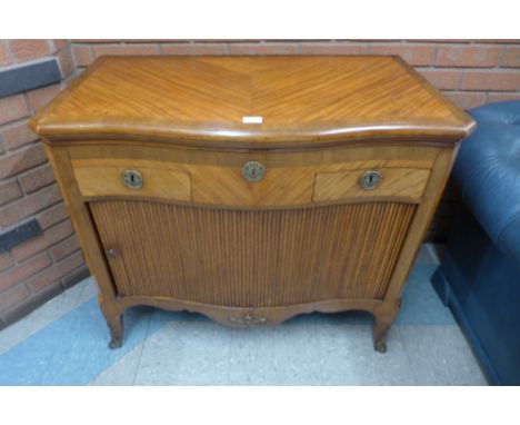 A 19th Century French satinwood and gilt metal mounted tambour front serpentine commode 
