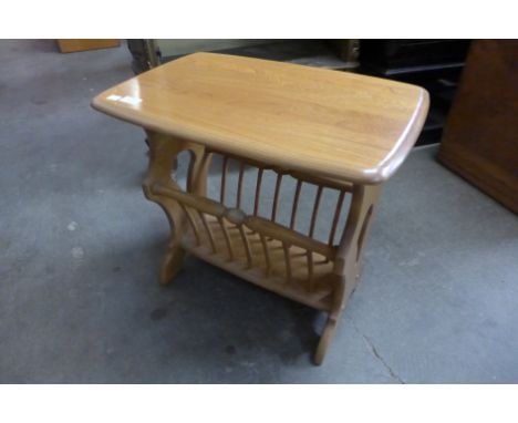 An Ercol elm magazine rack 