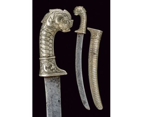 dating: 19th Century provenance: Indonesia Curved, single-edged blade with remains of engravings; grip and scabbard with silv