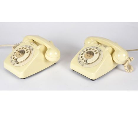 Two white vintage telephones,  both with rotary dials 