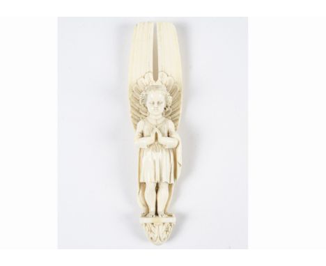 A 19th Century ivory Dieppe carved figure of an angel,   standing with hands together in prayer, upon an architectural style 