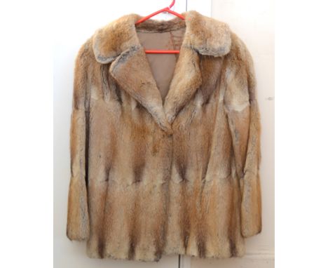 A lady's vintage three quarter length brown fur coat, with a brown satin lining, the monogram 'G M P' embroidered to the insi