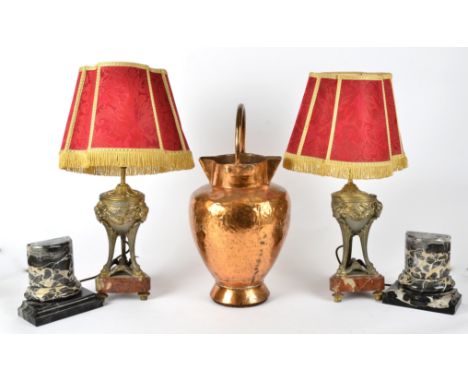 A pair of 19th Century metalwork rams head vessels later converted to lamps,  raised upon marble bases, height of the lamp ba