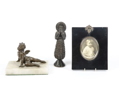A bronzed metalwork statue of an angel on a stone base,  supporting itself with outstretched arms, length 12cm, together with