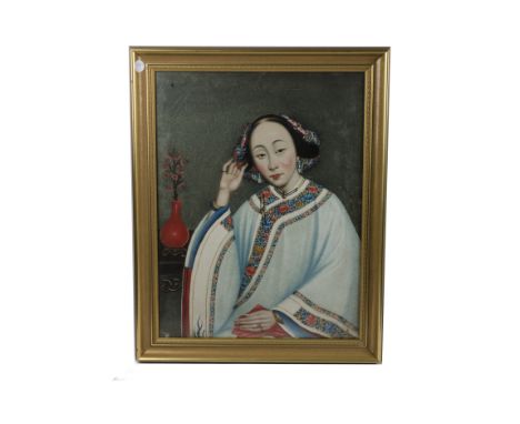 Two Chinese portraits attributed to Lam Qua (1801-1860),  one of a seated Lady in traditional Chinese costume, touching her h