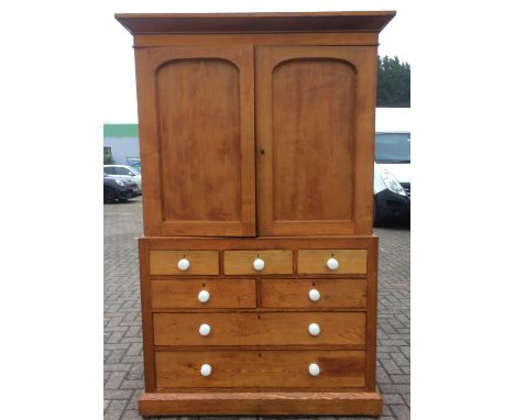 A 19th Century ash linen press, two arched panelled doors with ceramic handles to the top section and three interior shelves 