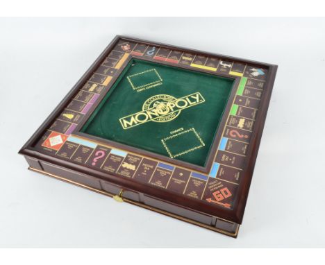 A Franklin Mint Collector's Edition Monopoly set, comes with gilt counters and hotels, vintage pattern property cards, chance