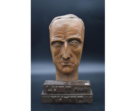 A carved wooden mask on stand commemorating the first thirty years of the Lust Naar Kunst theatre company, 1919-1949, signed 