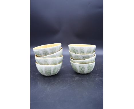 Eight Portuguese ceramic bowls in the form of cantaloupe melon halves, makers sticker to the base. H.6 W.13cm (8) 