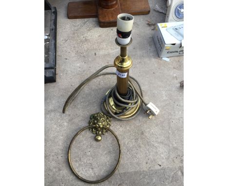 A BRASS LAMP AND A BRASS LION HEAD DOOR KNOCKER 