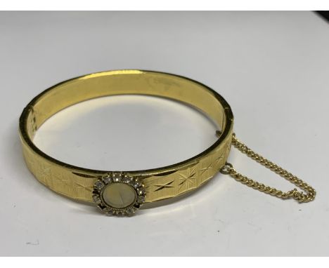A 22 CARAT GOLD PLATED BANGLE 