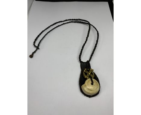 A TALISMAN GOOD LUCK AMULET ON LEATHER CORD 