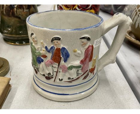 A VINTAGE STAFFORDSHIRE MUG WITH EMBOSSED FIGURES AND A FROG INSIDE, HEIGHT 12CM 