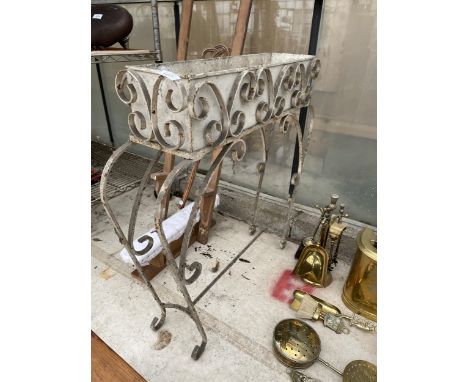 A DECORATIVE WROUGHT IRON PLANT STAND WITH PLANTER 