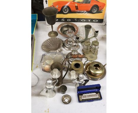 A QUANTITY OF SILVER PLATED AND BRASS ITEMS TO INCLUDE CANDLESTICKS, A LARGE GOBLET, ANGEL CANDLE HOLDERS, A HOHNER 'BLUES HA
